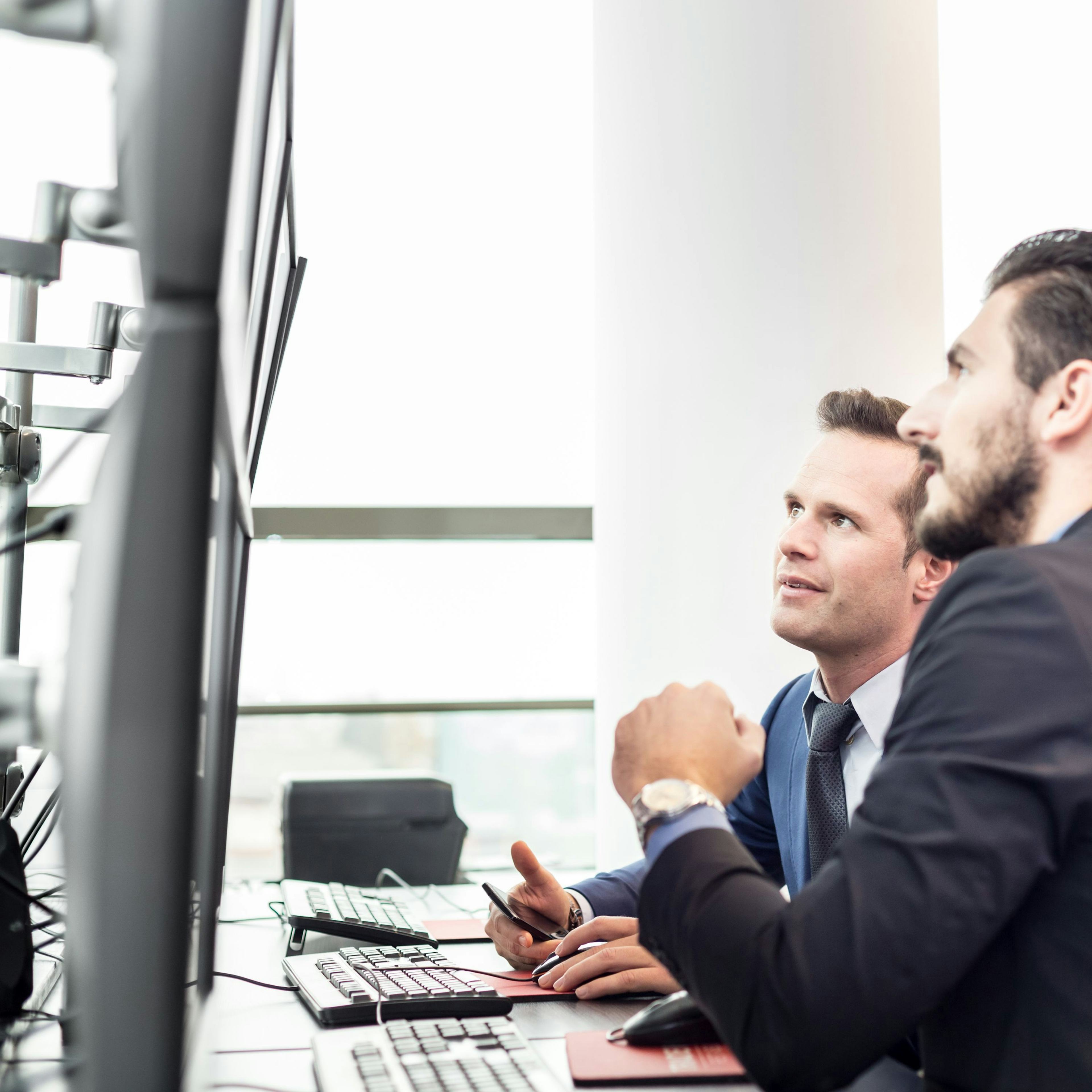 men looking at screen 