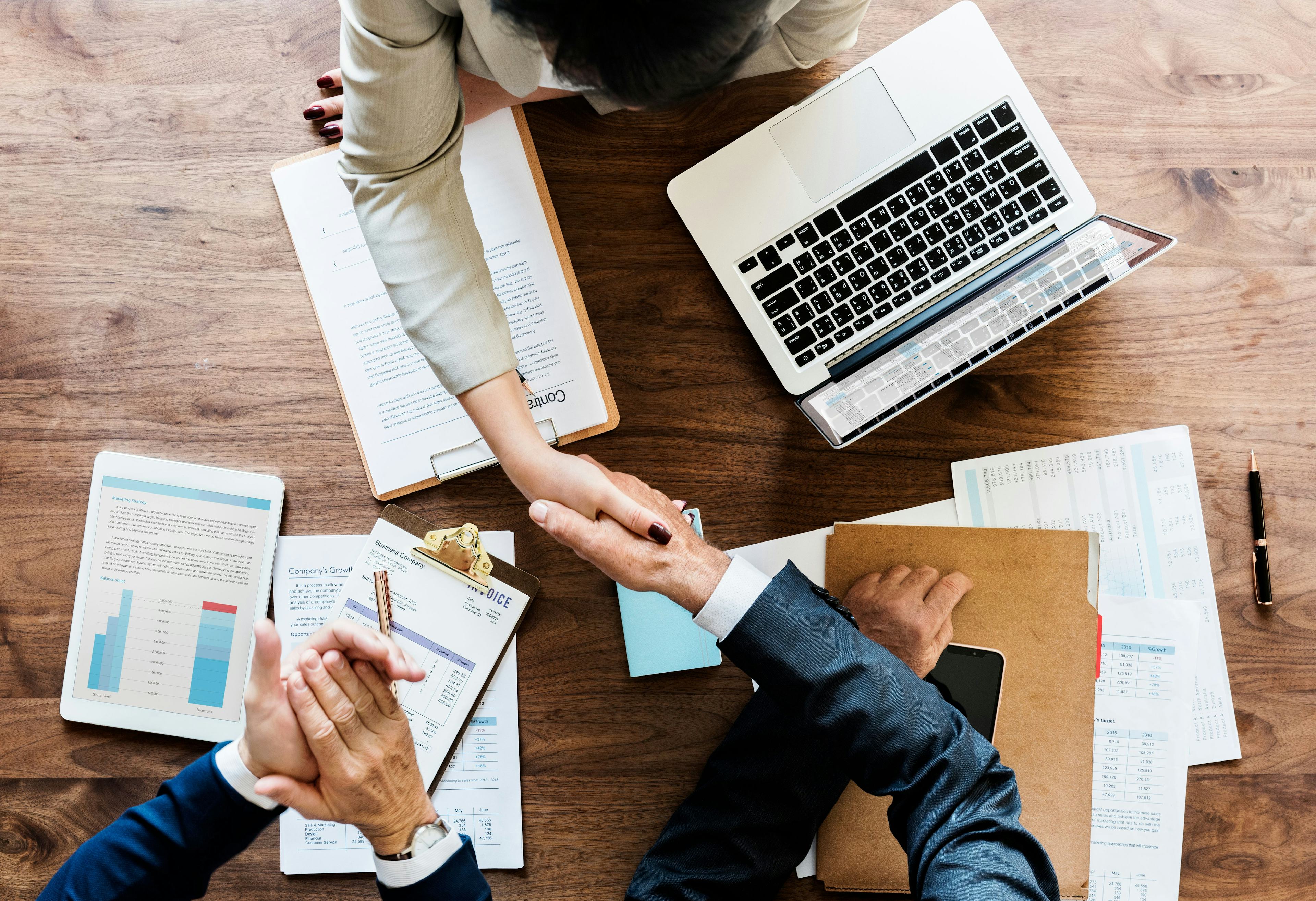 Two people shaking hands in a meeting