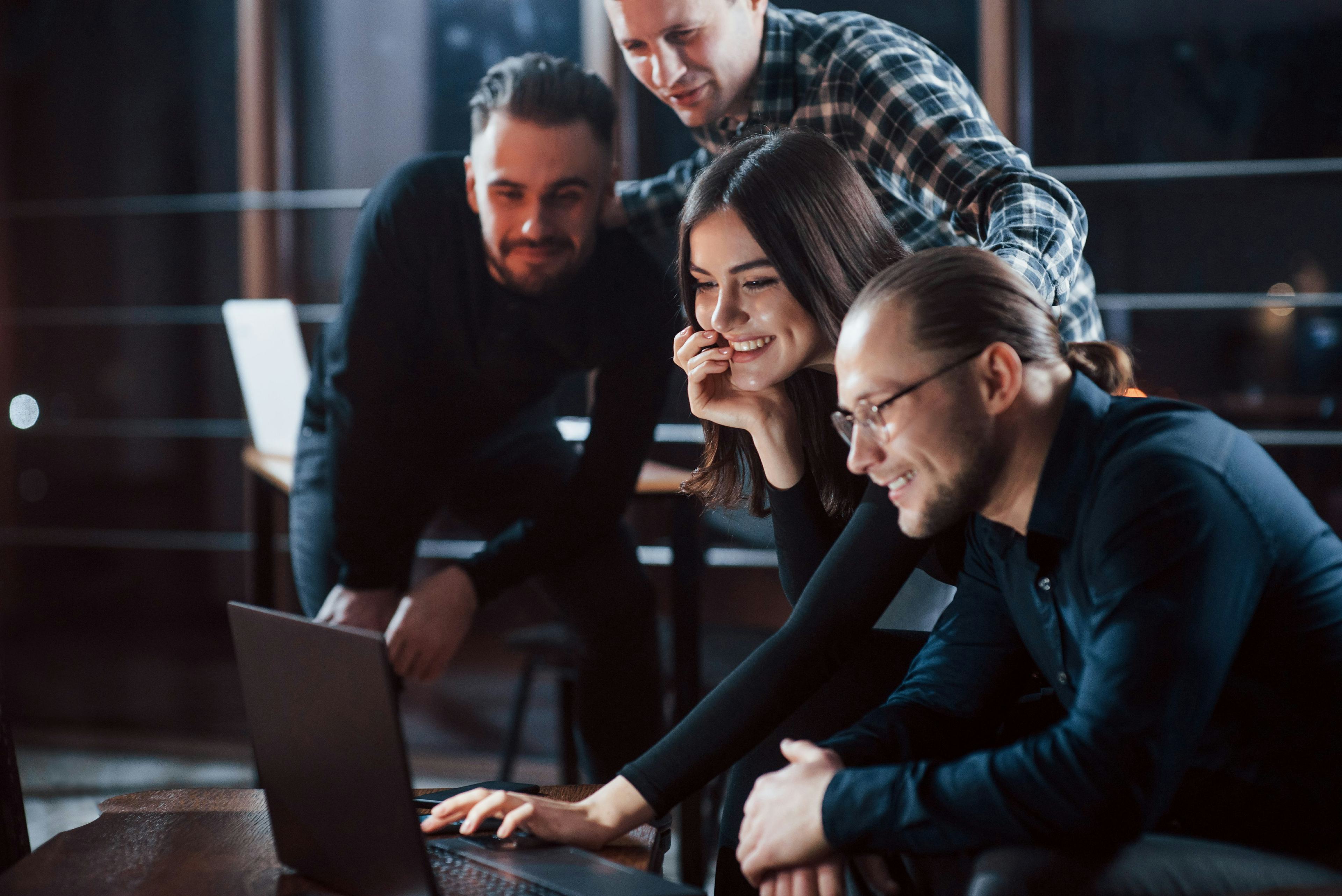 a group of people looking at a computer