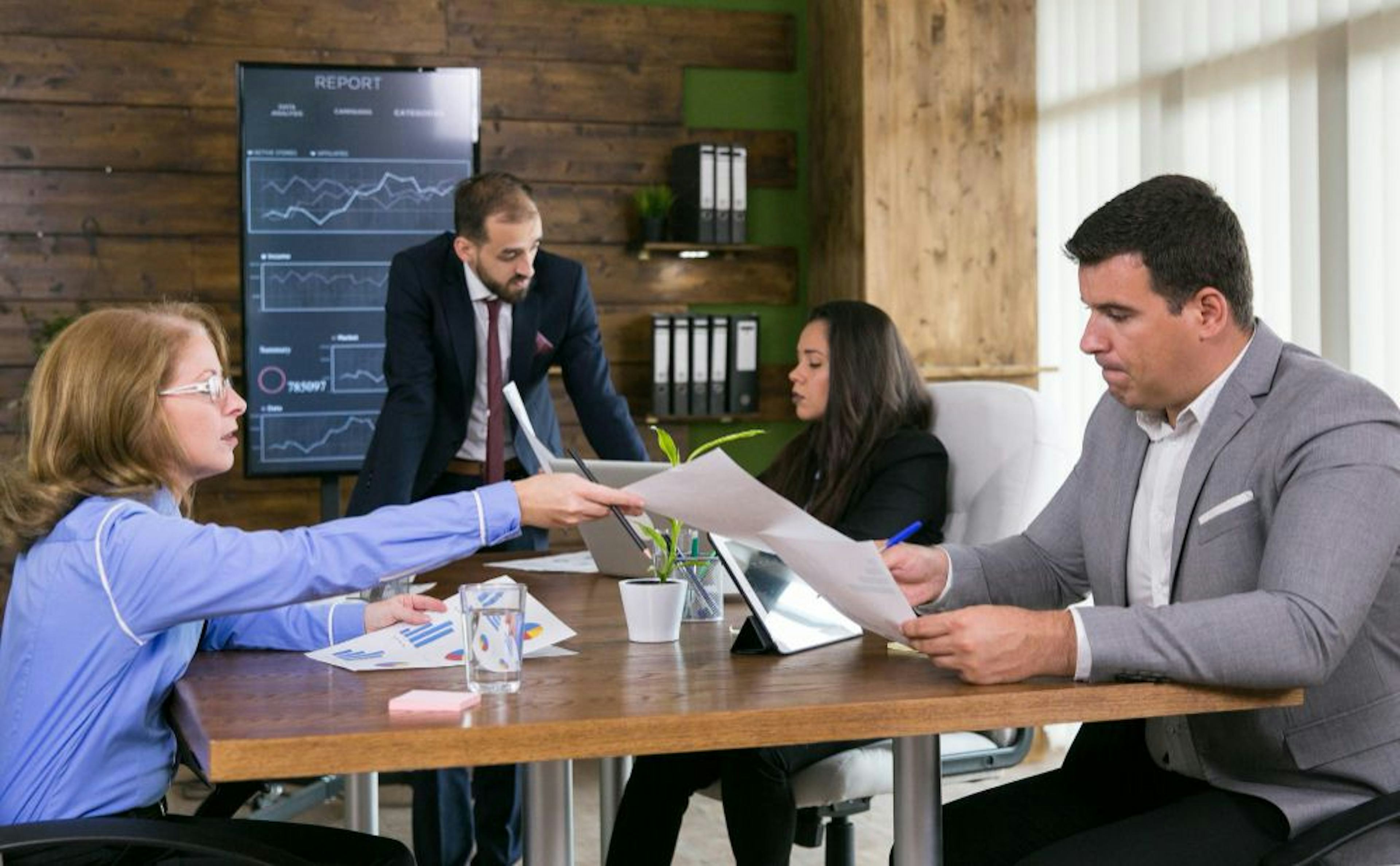 four persons working in office