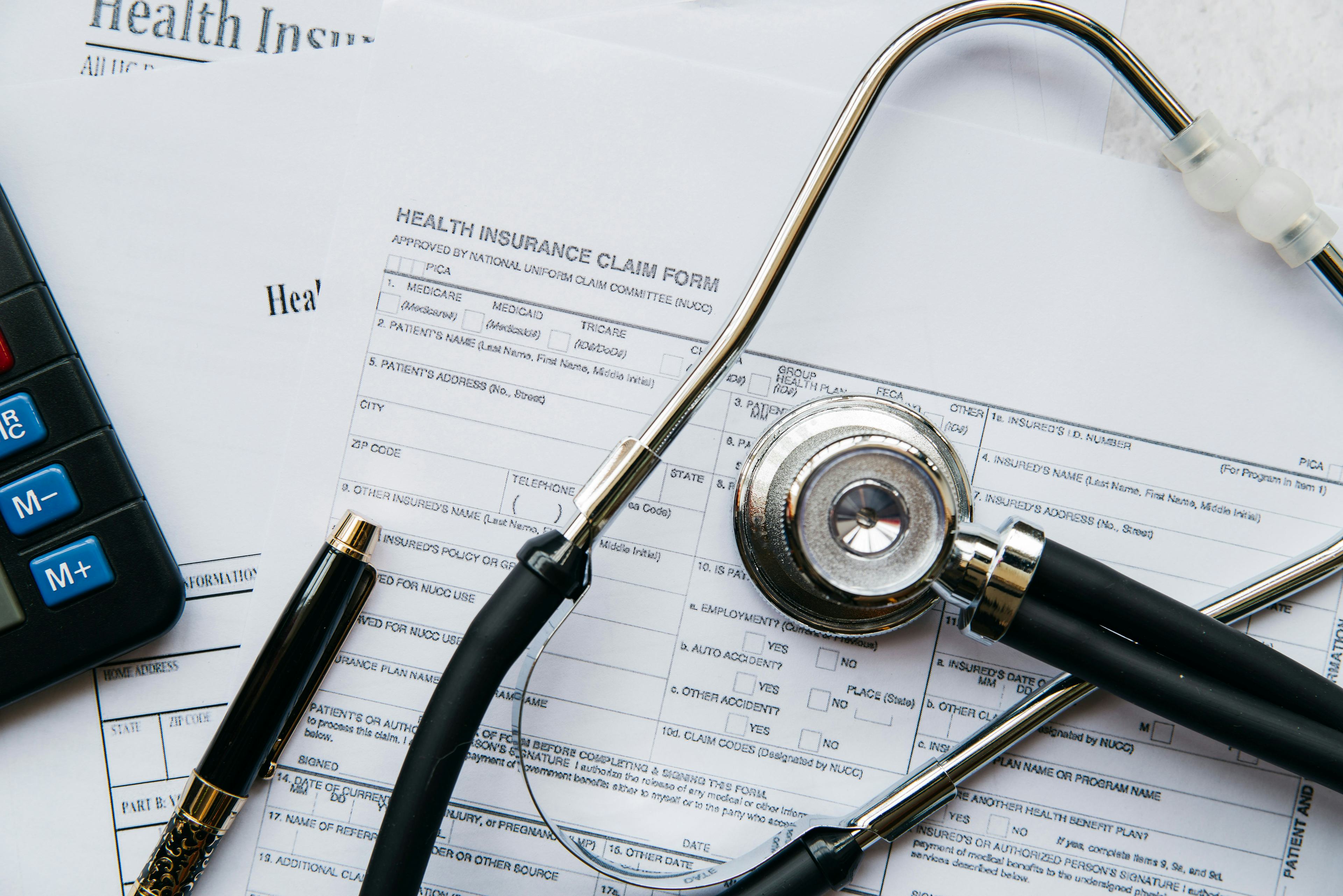 aerial view of stethoscope on patient health forms