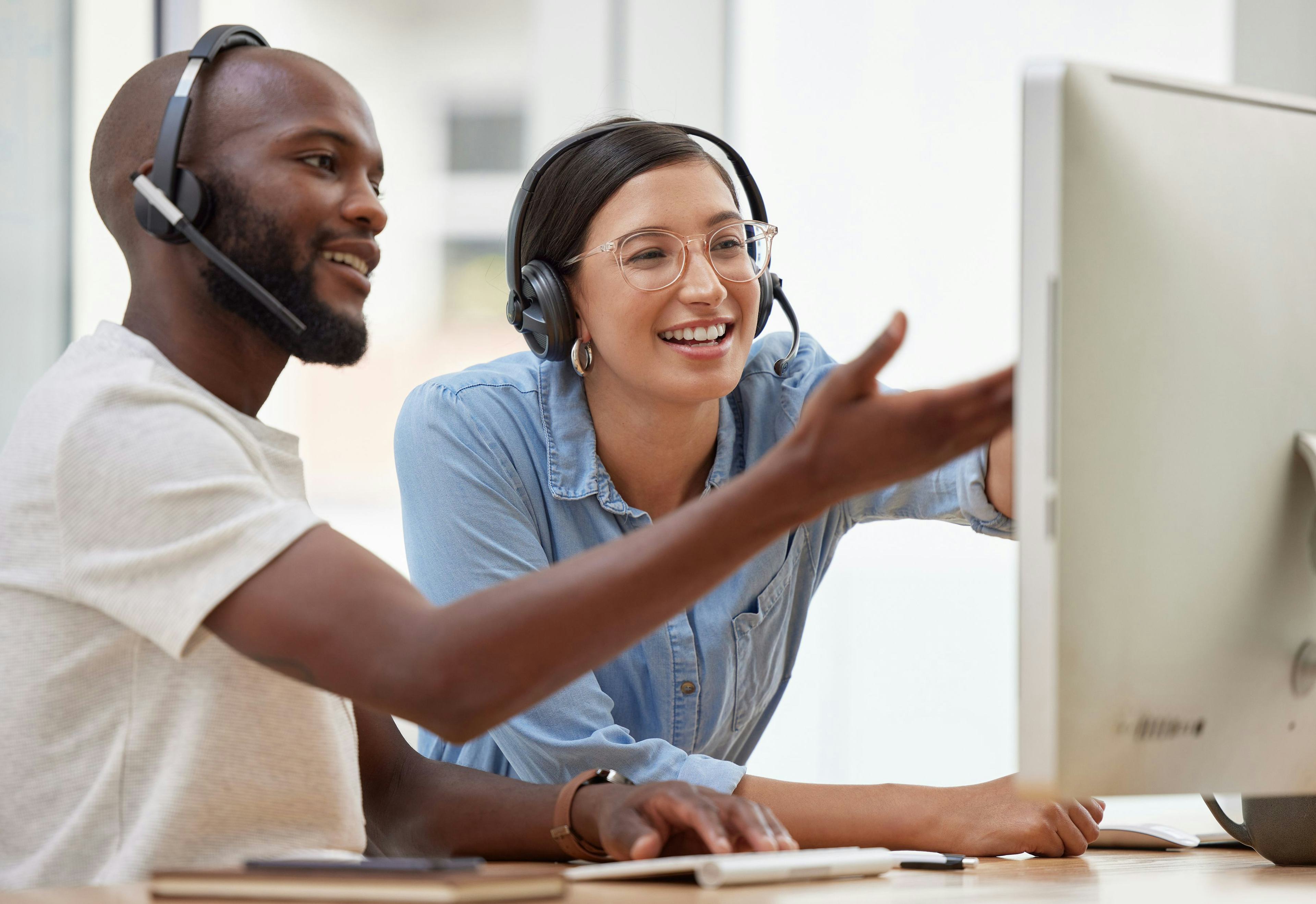 a man and woman looking at a computer