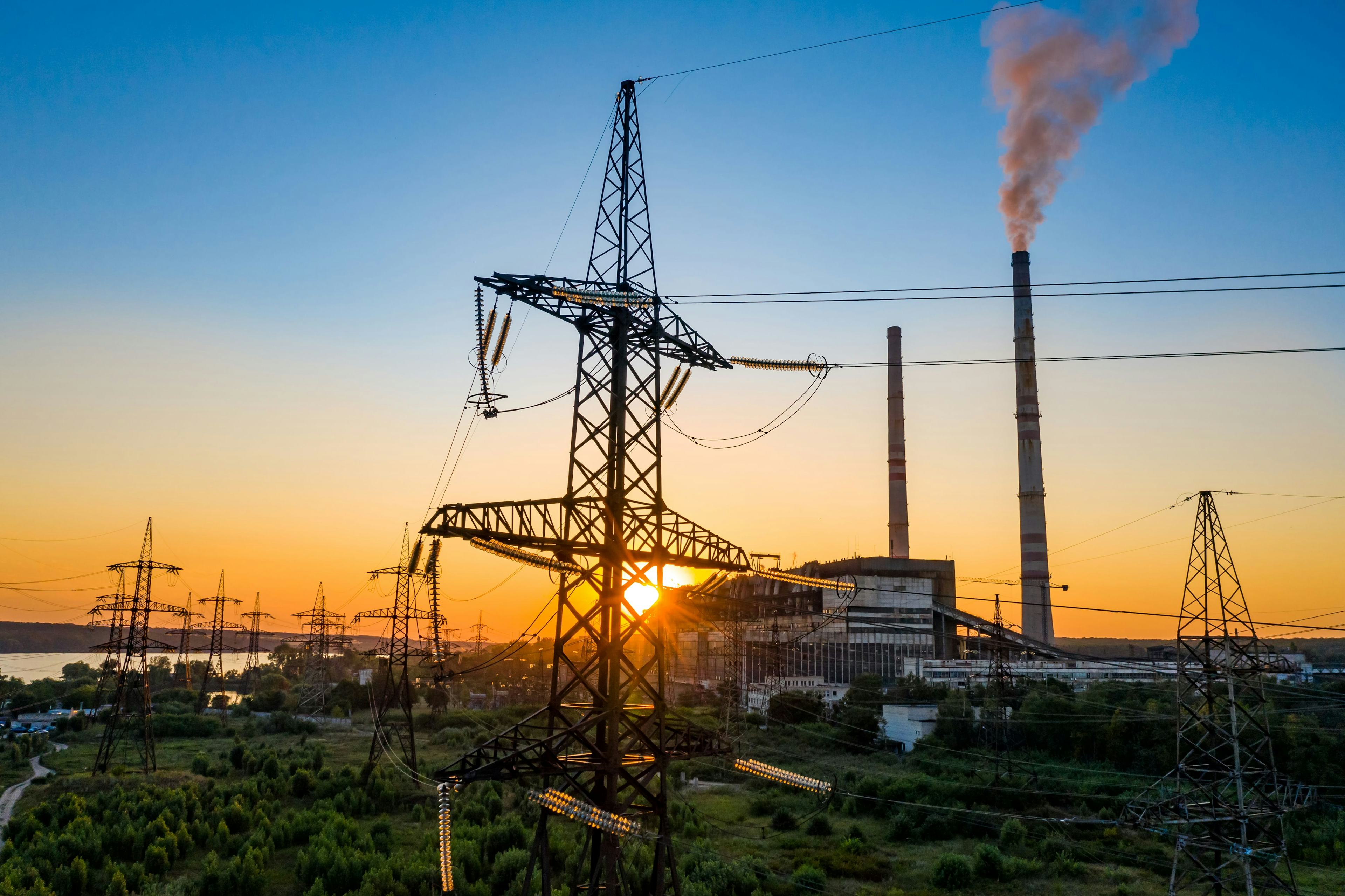 Electricity towers with setting sun in the backdrop