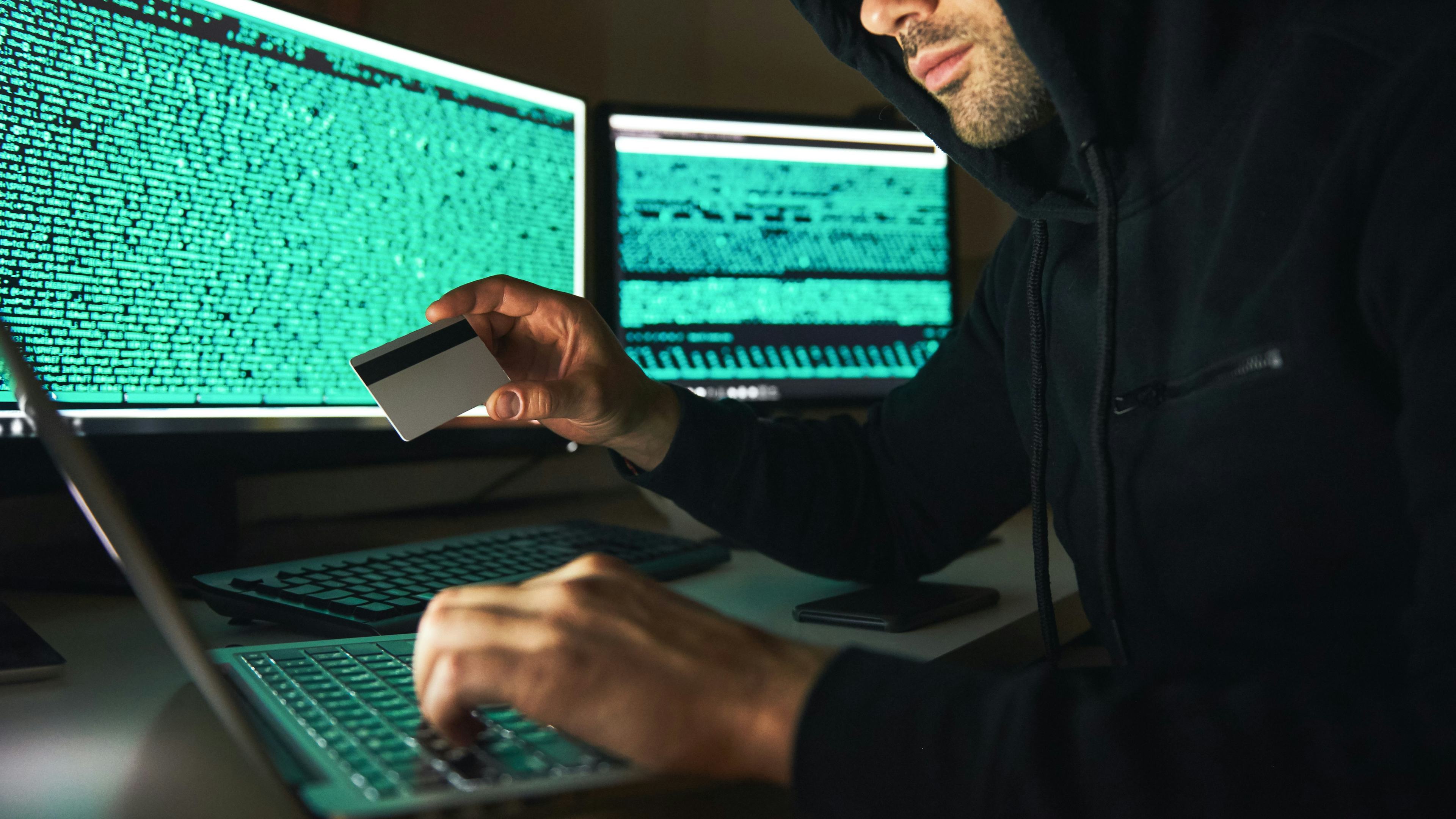 Hacker putting in card information into a computer