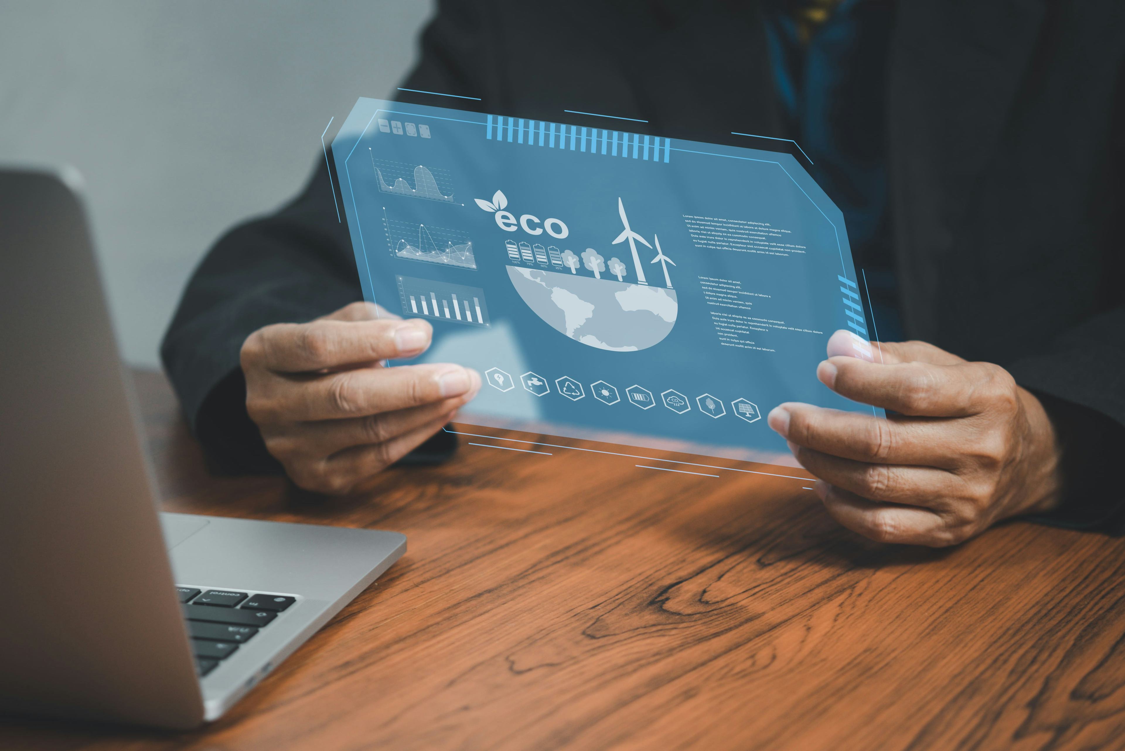 Man holding screen displaying eco-friendly analytics