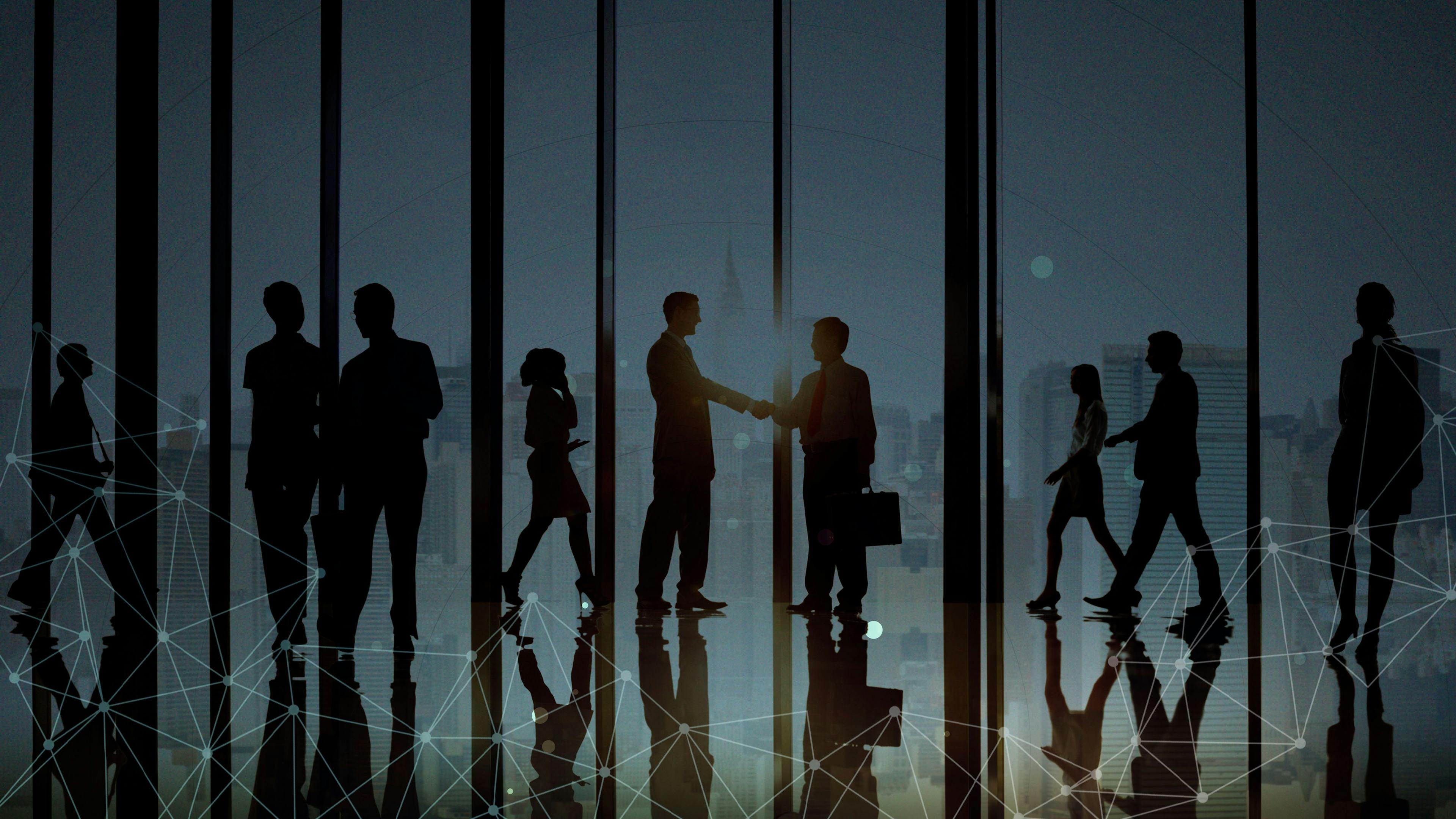 silhouettes of people walking together and shaking hands