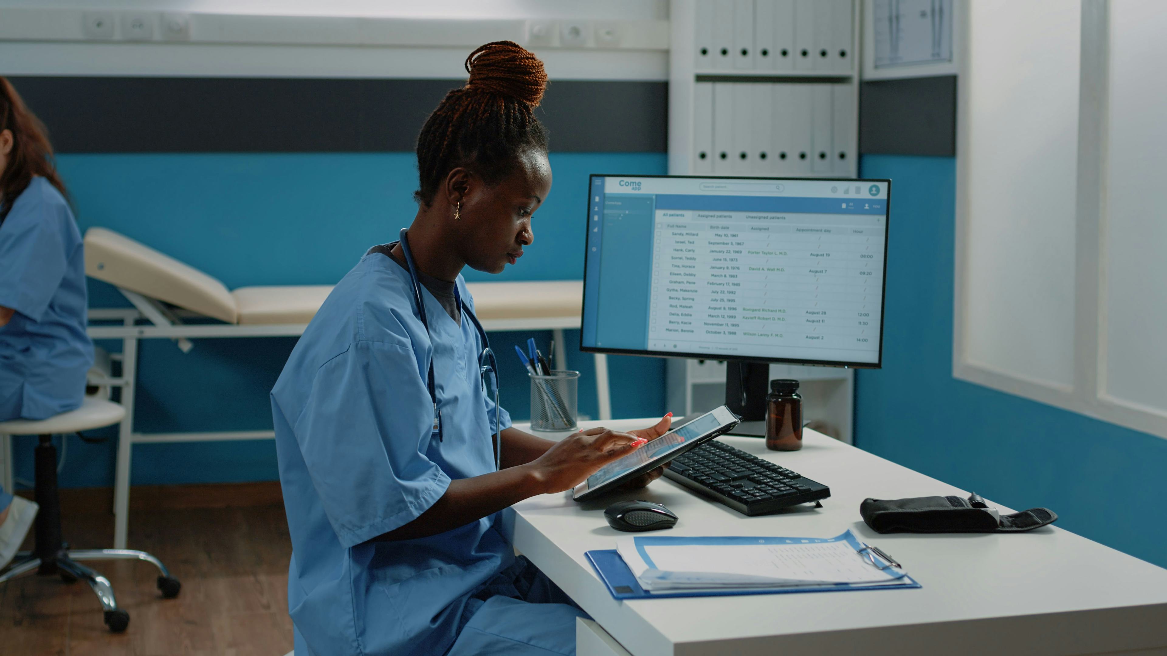 doctor viewing medical information on tablet and laptop