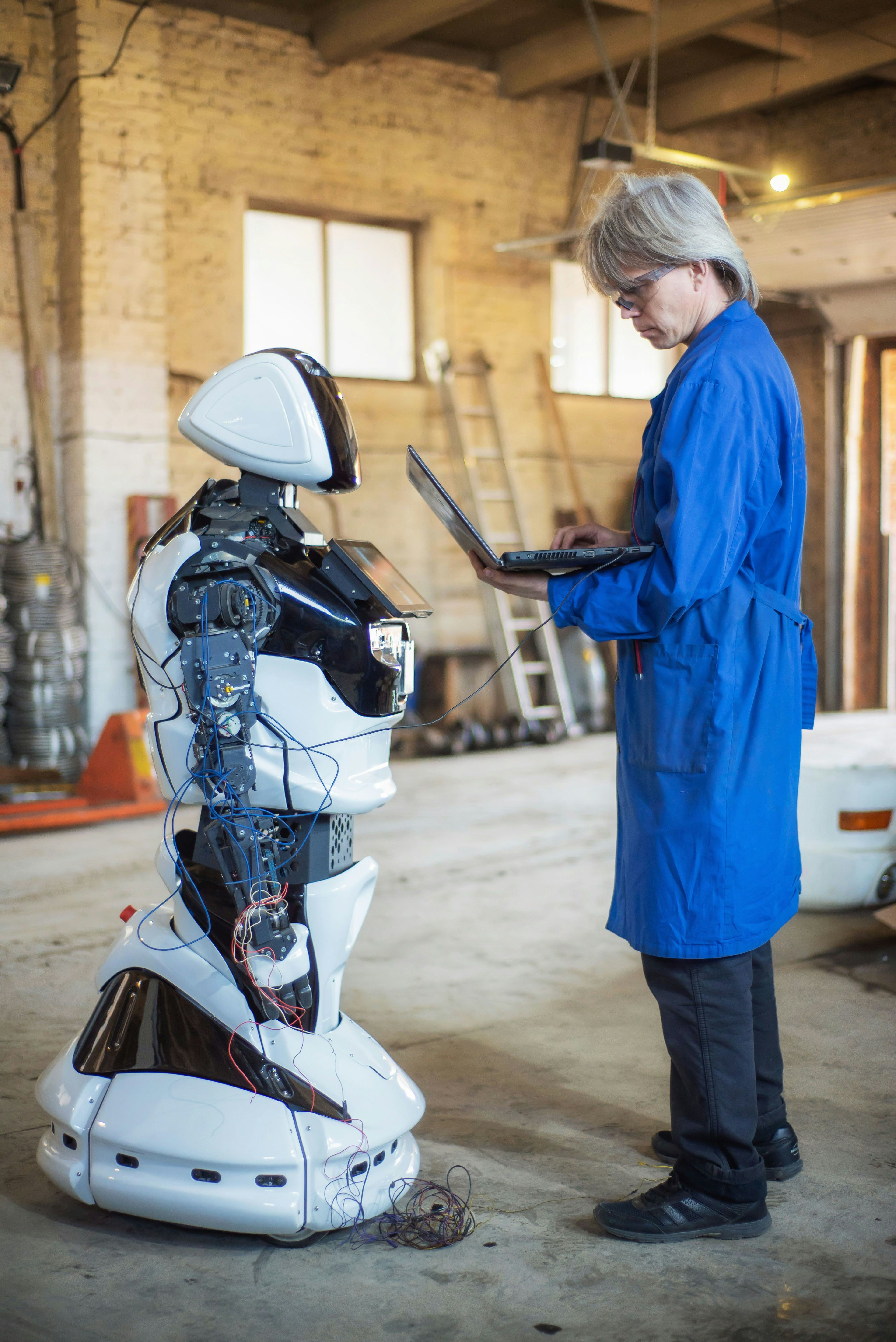 Full length of man working on robot