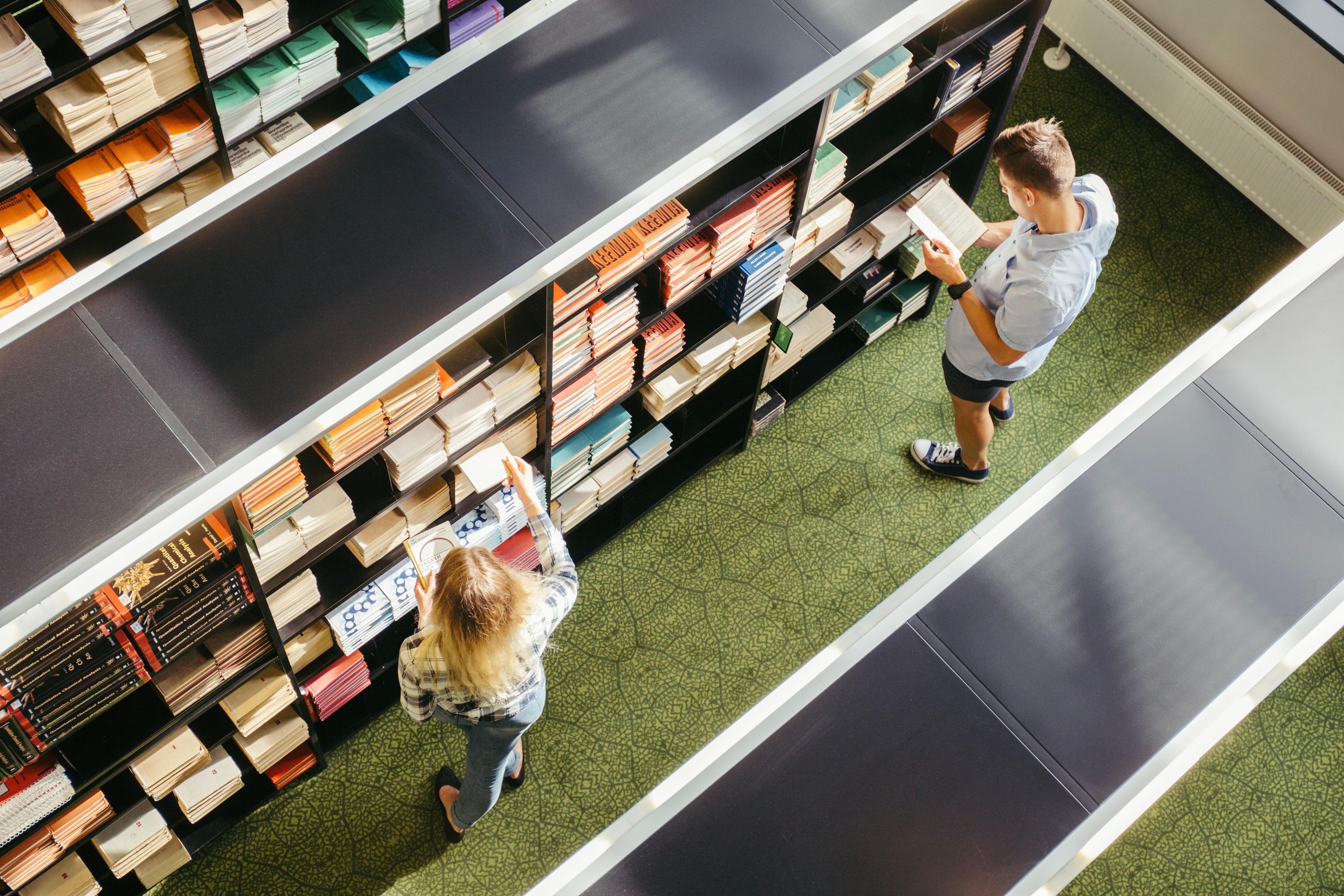 aerial view of students perusing library shelves