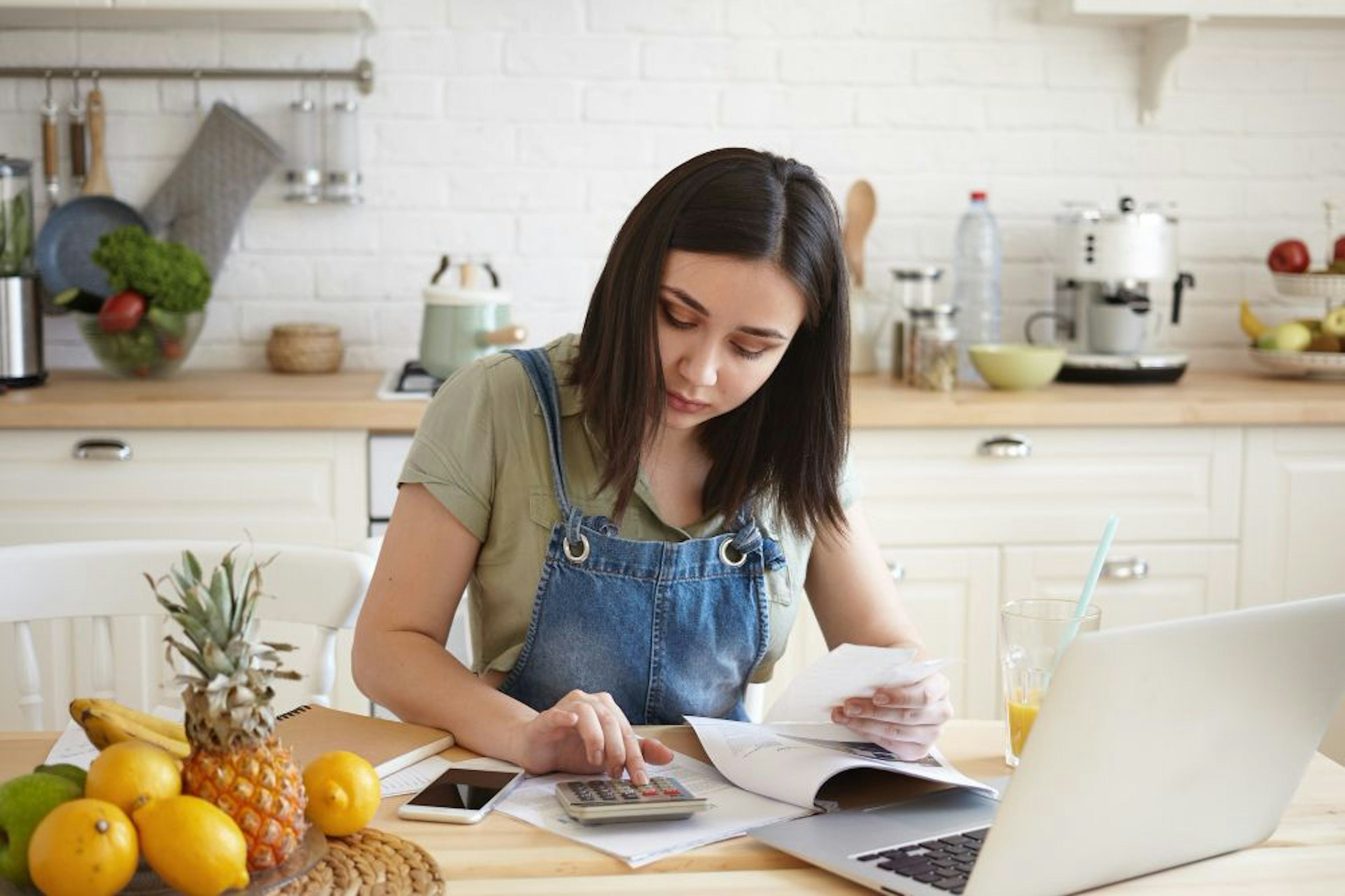 Woman working documnets and calucaulator