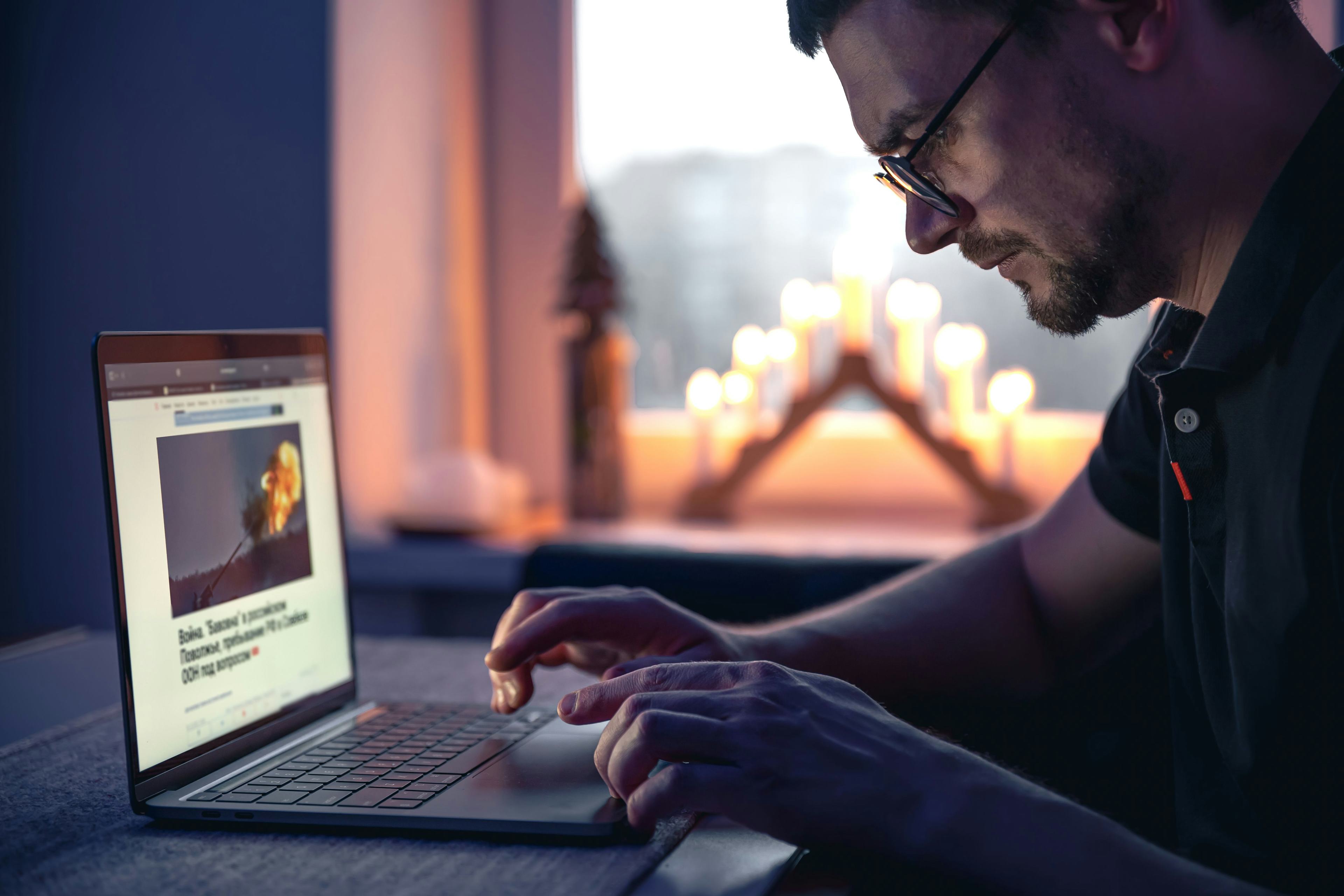 a man navigating a website on open laptop