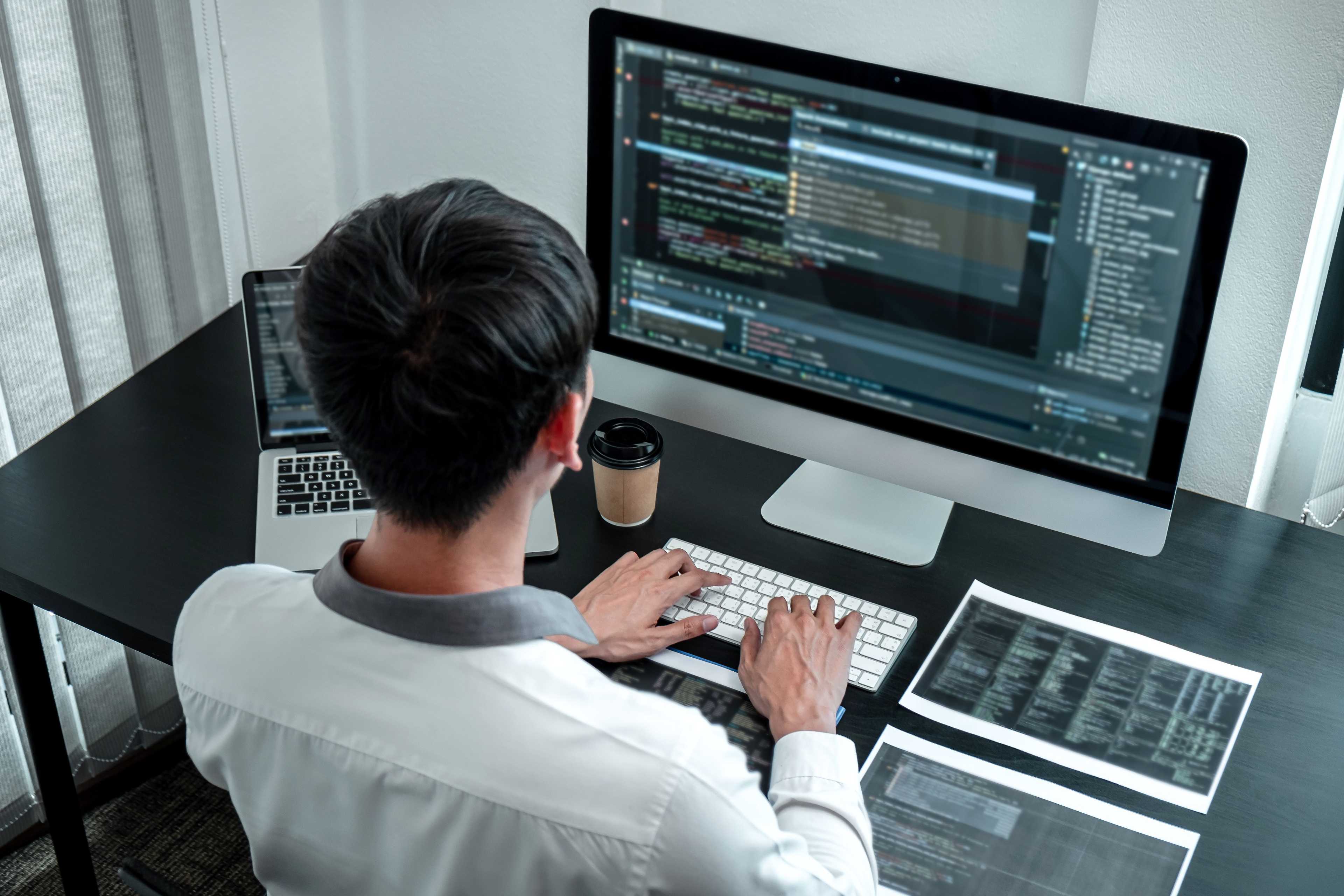 A man coding on computer