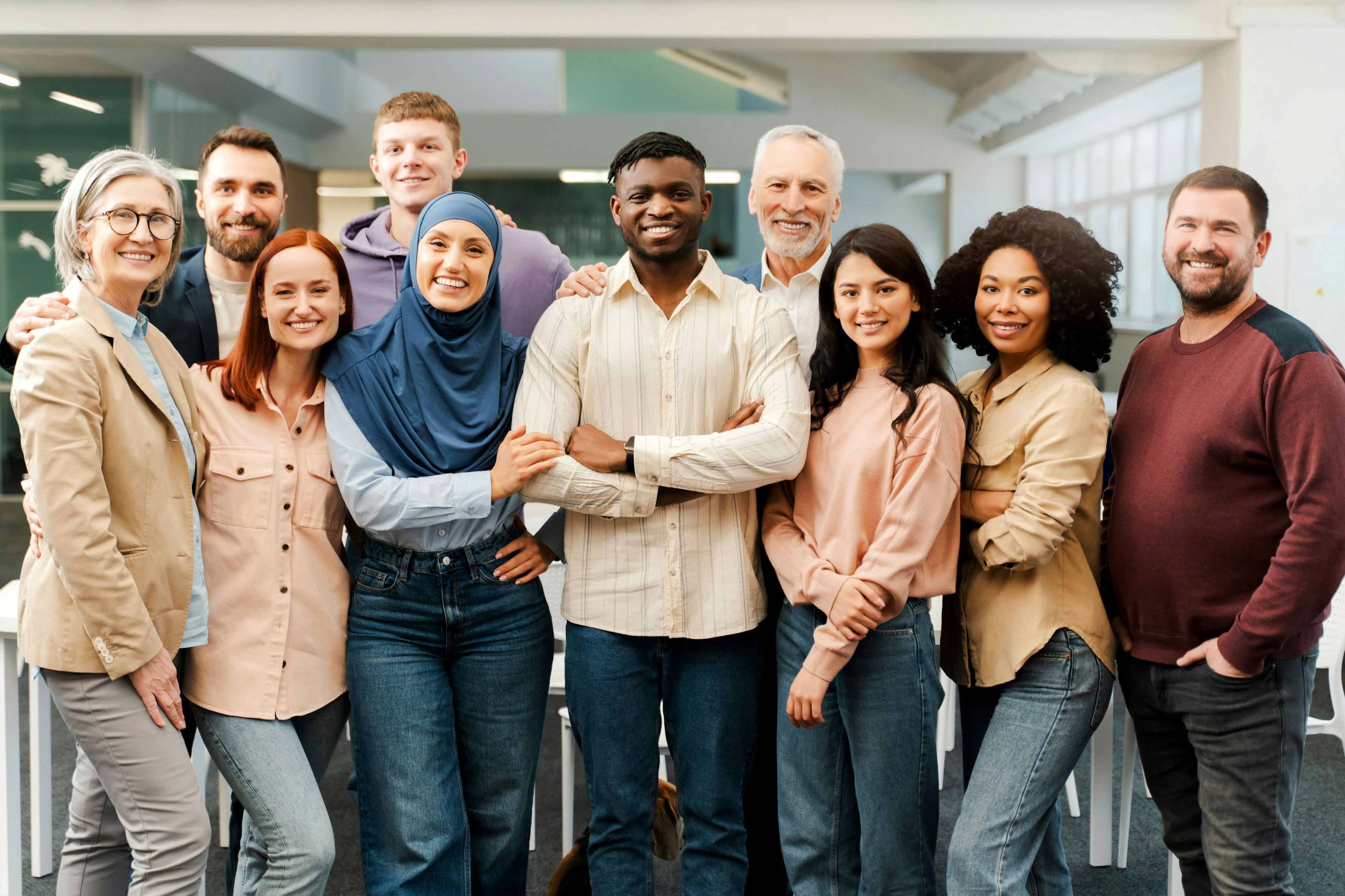 Group portrait of smiling multiracial business people looking at camera in modern office Meeting