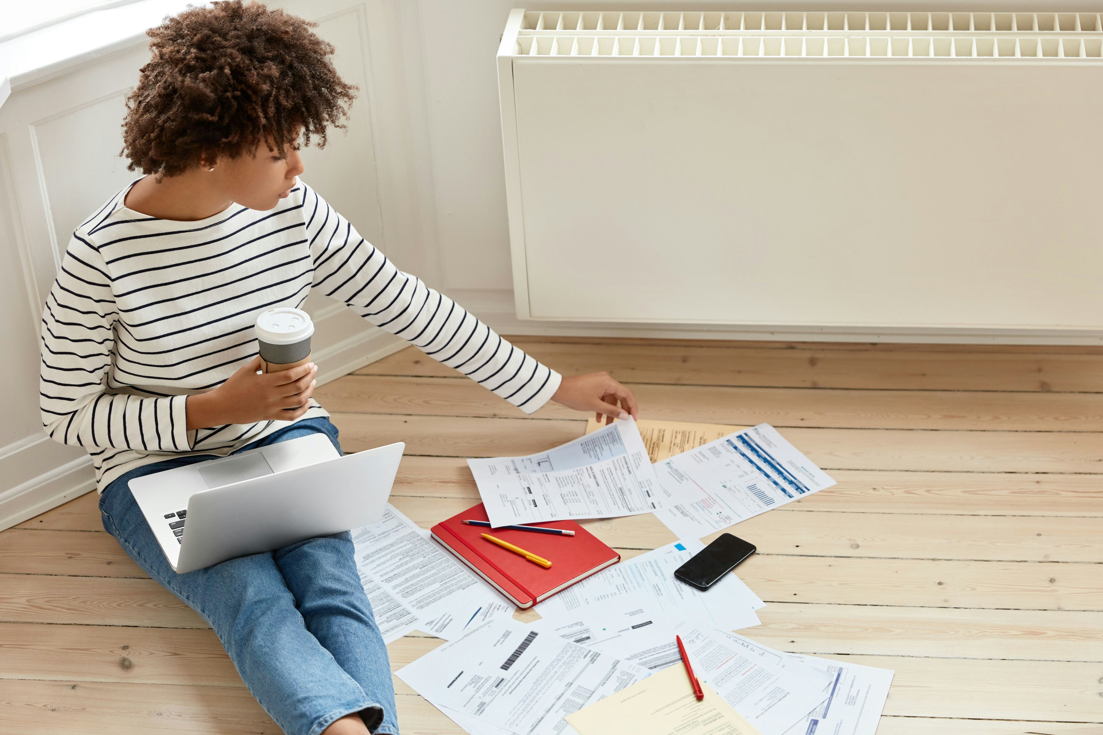 woman sitting on floor with papers