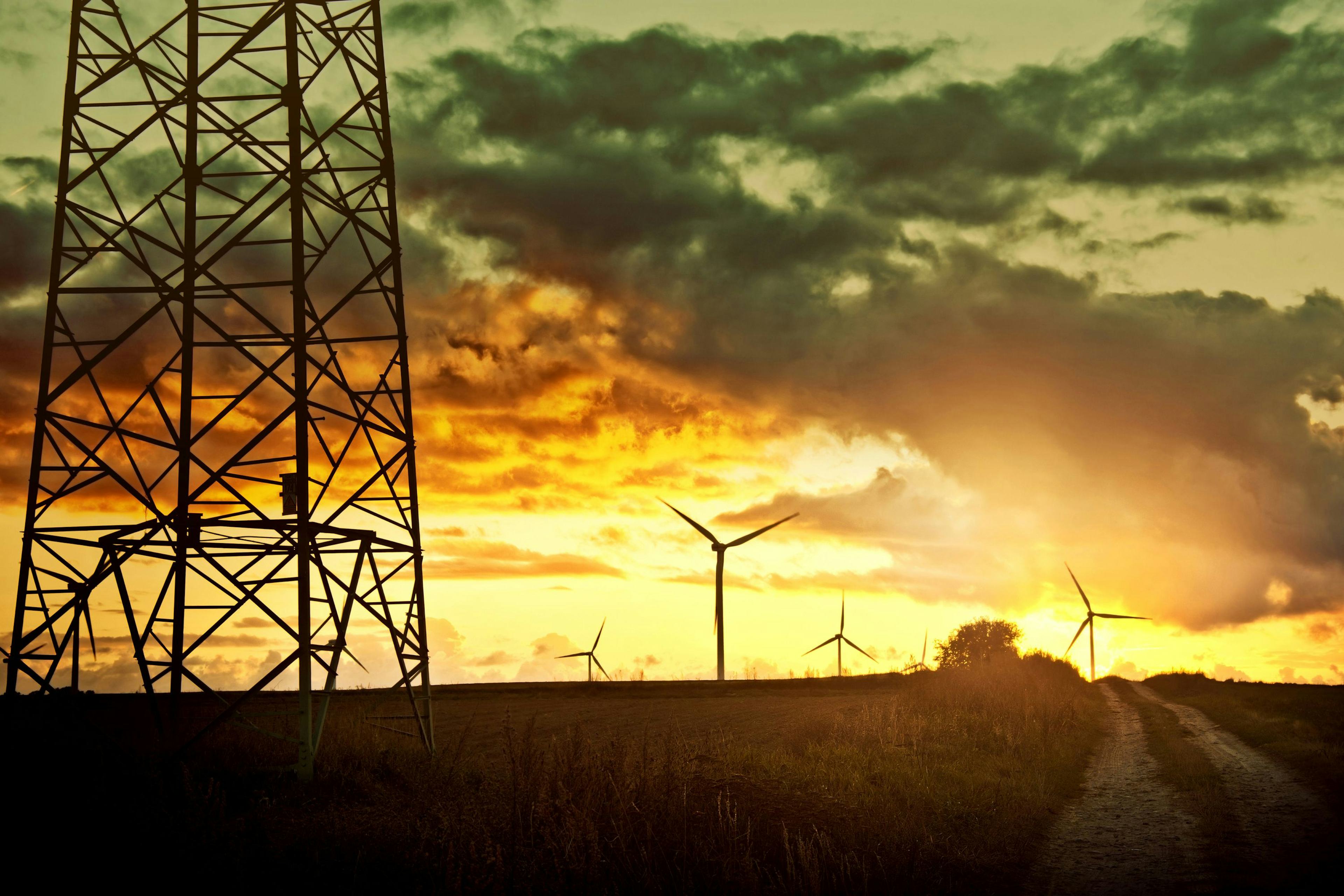 turbines in the fields at sunset