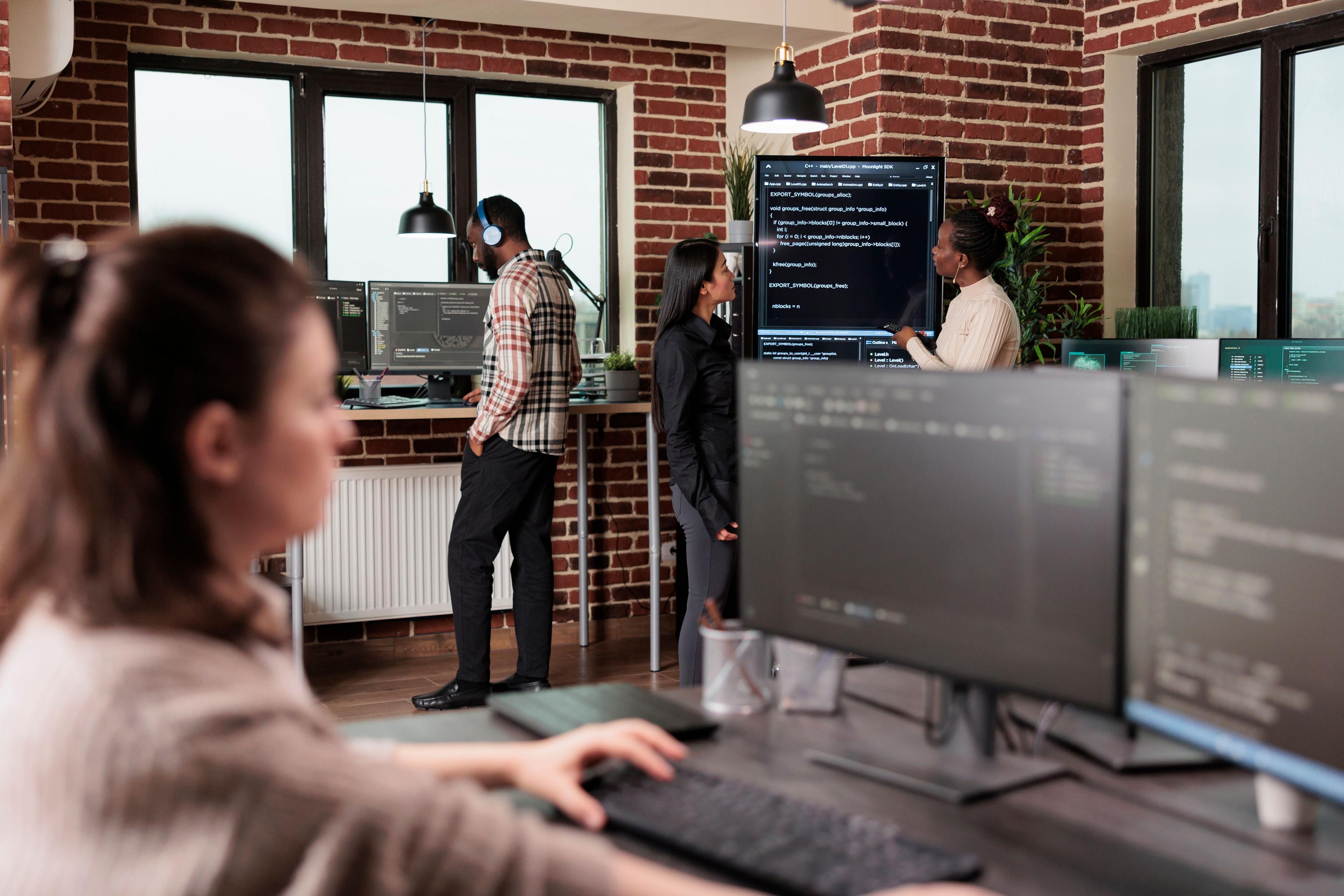 Team of developers working in front of screens