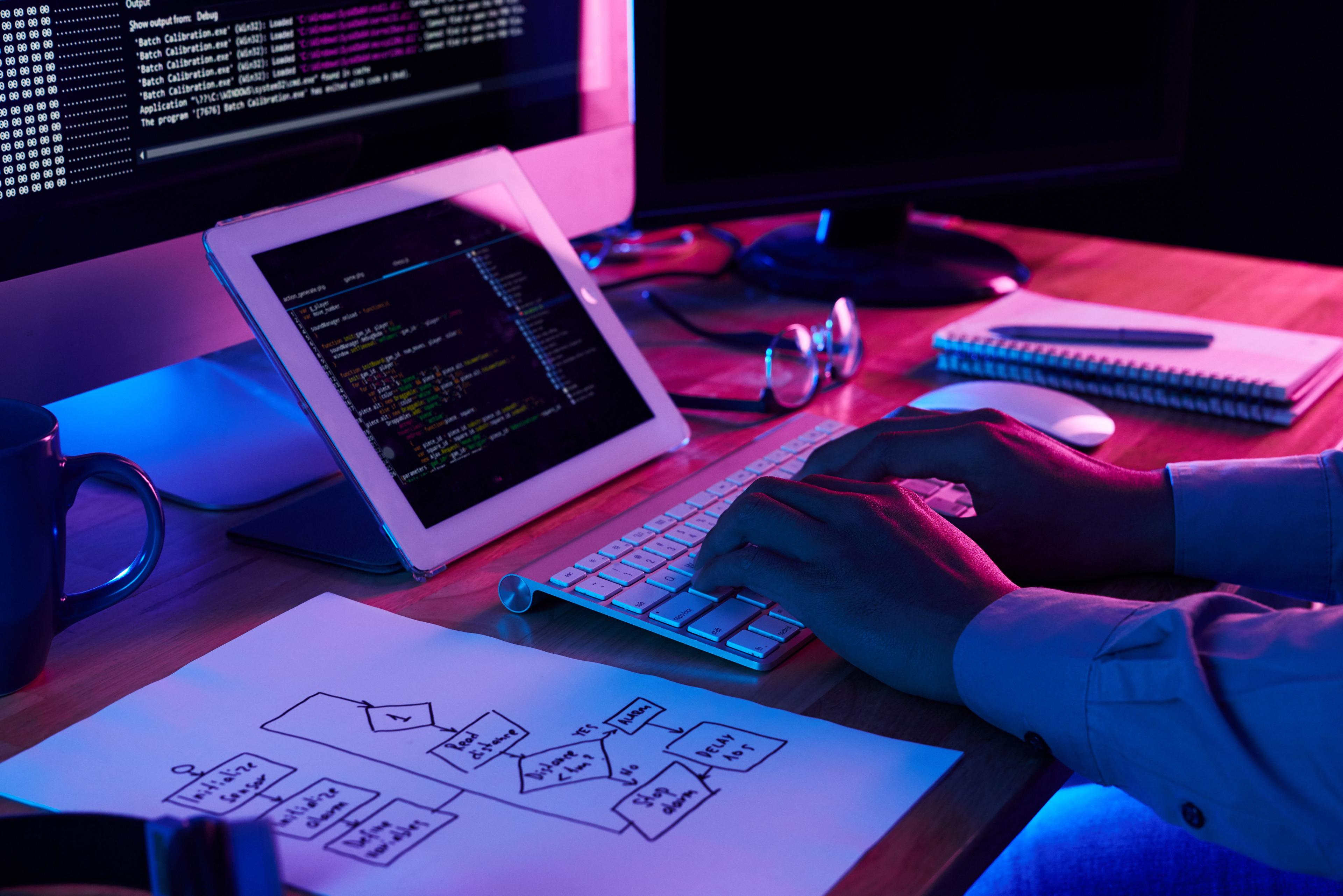 Close-up image of programmer working at his desk in office