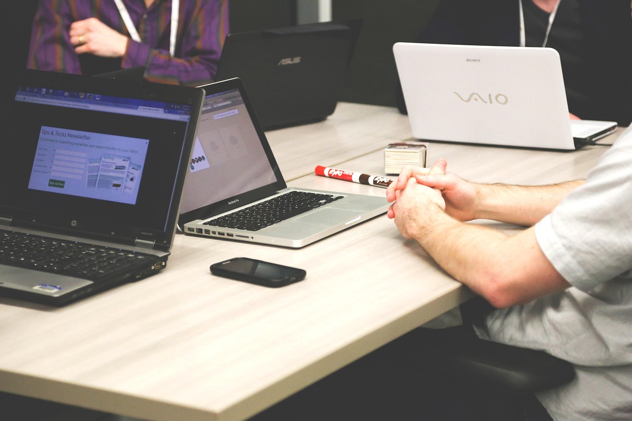 Team meeting in a modern conference room with laptops
